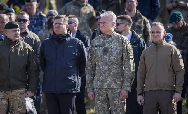 From left, Chief of the General Staff of the Polish Armed Forces Gen. Wieslaw Kukula, Lithuanian Defense Minister Laurynas Kasciunas, Lithuania's President Gitanas Nauseda and Poland's President Andrej Duda to watch a Lithuanian-Polish Brave Griffin 24/II military exercise near the Suwalki Gap near the Polish border at the Dirmiskes village, Alytus district west of the capital Vilnius in Lithuania on Friday, April 26, 2024. Over 1500 troops and 200 pieces of tactical equipment are rehearsing defence scenarios under the bilateral Lithuanian-Polish Orsha Plan near the Suwalki Gap. (AP Photo/Mindaugas Kulbis)