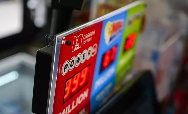 A sign for the Powerball jackpot is displayed at a 7-Eleven, Friday, April 5, 2024, in Portland, Ore. (AP Photo/Jenny Kane)