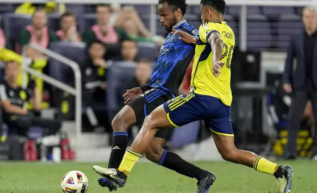 San Jose Earthquakes forward Ousseni Bouda, left, and Nashville SC midfielder Anibal Godoy (20) chase the ball during the second half of an MLS soccer match Saturday, April 27, 2024, in Nashville, Tenn. The Earthquakes and Nashville played to a 1-1 draw. (AP Photo/George Walker IV)