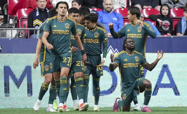 LA Galaxy's Joseph Paintsil, front right, celebrates his goal against the Vancouver Whitecaps during the second half of an MLS soccer match Saturday, April 13, 2024, in Vancouver, British Columbia. (Darryl Dyck/The Canadian Press via AP)