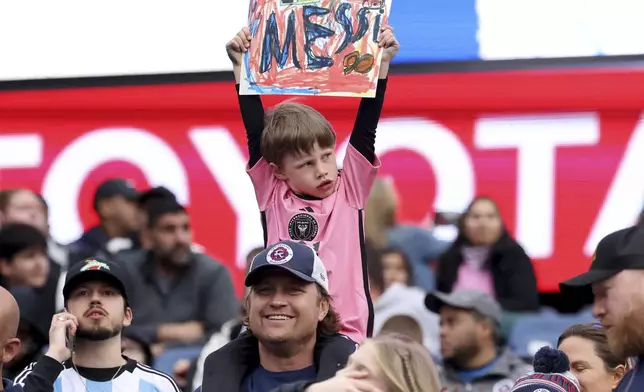 A young fan shows his support for Inter Miami forward Lionel Messi before an MLS soccer match against the New England Revolution, Saturday, April 27, 2024, in Foxborough, Mass. (AP Photo/Mark Stockwell)