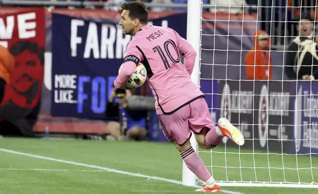 Inter Miami forward Lionel Messi (10) retrieves the ball from the net after scoring in the first half of an MLS soccer match against the New England Revolution, Saturday, April 27, 2024, in Foxborough, Mass. (AP Photo/Mark Stockwell)