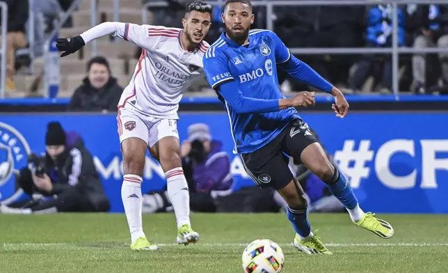 Orlando City's Martin Ojeda, left, and CF Montreal's George Campbell, right, watch the ball during second-half MLS soccer match action in Montreal, Saturday, April 20, 2024. (Graham Hughes/The Canadian Press via AP)