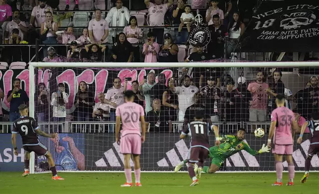 Colorado Rapids forward Rafael Navarro (9) scores against Inter Miami goalkeeper Drake Callender (1) on a penalty kick during the first half of an MLS soccer match Saturday, April 6, 2024, in Fort Lauderdale, Fla. (AP Photo/Rebecca Blackwell)