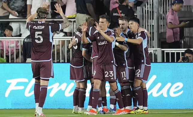 Colorado Rapids, including midfielder Cole Bassett (23), celebrate a goal against Inter Miami by forward Rafael Navarro, obscured, during the first half of an MLS soccer match Saturday, April 6, 2024, in Fort Lauderdale, Fla. (AP Photo/Rebecca Blackwell)