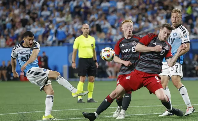 Charlotte FC forward Liel Abada, left, shoots against Toronto FC midfielder Matty Longstaff, second from right, and defender Kevin Long, right, during the first half of an MLS soccer match in Charlotte, N.C., Saturday, April 13, 2024. (AP Photo/Nell Redmond)