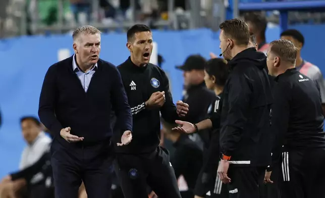 Charlotte FC coach Dean Smith, left, argues a call during the second half of the team's MLS soccer match against Toronto FC in Charlotte, N.C., Saturday, April 13, 2024. (AP Photo/Nell Redmond)
