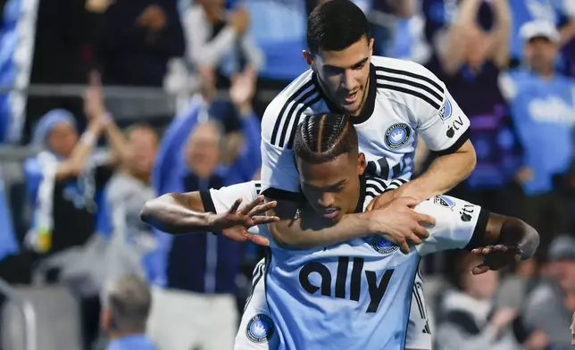 Charlotte FC forward Kerwin Vargas, front, celebrates with forward Liel Abada after scoring a goal against Toronto FC during the first half of an MLS soccer match in Charlotte, N.C., Saturday, April 13, 2024. (AP Photo/Nell Redmond)