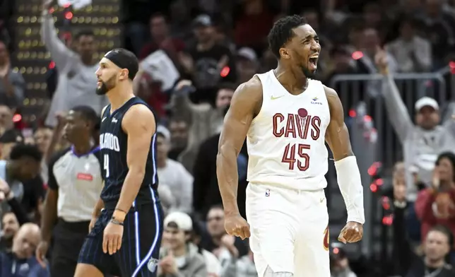 Cleveland Cavaliers' Donovan Mitchell (45) celebrates making a 3-point basket during the second half against the Orlando Magic in Game 1 of an NBA basketball first-round playoff series, Saturday, April 20, 2024, in Cleveland. (AP Photo/Nick Cammett)