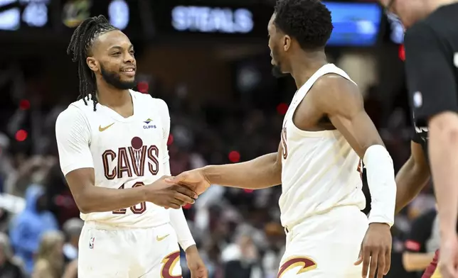 Cleveland Cavaliers' Darius Garland (10) and Donovan Mitchell (45) celebrate a 3-point basket made by Mitchell during the second half against the Orlando Magic in Game 1 of an NBA basketball first-round playoff series, Saturday, April 20, 2024, in Cleveland. (AP Photo/Nick Cammett)
