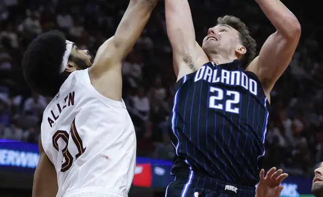 Cleveland Cavaliers center Jarrett Allen (31) blocks a shot by Orlando Magic forward Franz Wagner (22) during the second half of Game 2 of an NBA basketball first-round playoff series, Monday, April 22, 2024, in Cleveland. (AP Photo/Ron Schwane)