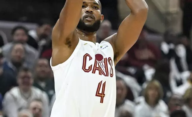 Cleveland Cavaliers' Evan Mobley shoots a 3-point basket during the first half in Game 1 of an NBA basketball first-round playoff series against the Orlando Magic, Saturday, April 20, 2024, in Cleveland. (AP Photo/Nick Cammett)