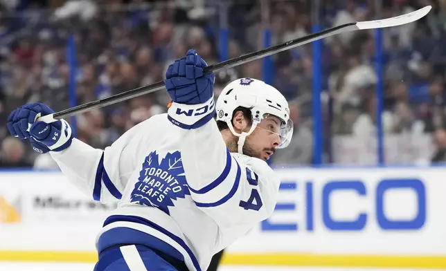 Toronto Maple Leafs' Auston Matthews shoots against the Tampa Bay Lightning during the first period of an NHL hockey game Wednesday, April 17, 2024, in Tampa, Fla. (Frank Gunn/The Canadian Press via AP)