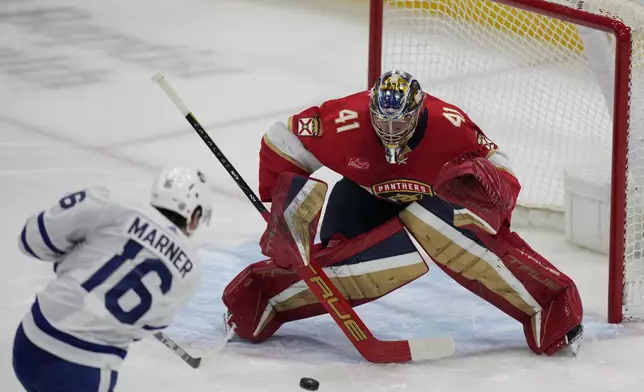 Toronto Maple Leafs right wing Mitch Marner (16) attempts a shot at Florida Panthers goaltender Anthony Stolarz (41) during the first period of an NHL hockey game, Tuesday, April 16, 2024, in Sunrise, Fla. (AP Photo/Wilfredo Lee)