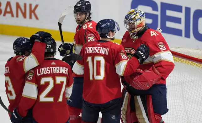 Florida Panthers players celebrate after beating the Toronto Maple Leafs 5-2, during an NHL hockey game, Tuesday, April 16, 2024, in Sunrise, Fla. (AP Photo/Wilfredo Lee)