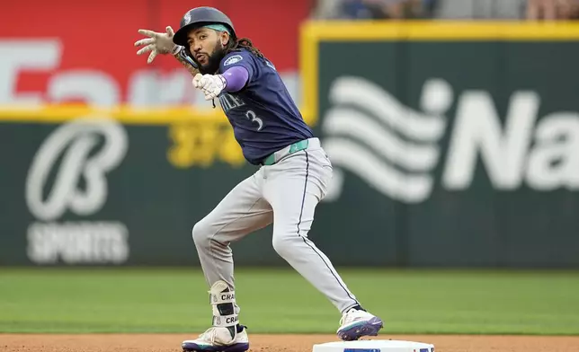 Seattle Mariners' J.P. Crawford celebrates after hitting for a double in the first inning of a baseball game against the Texas Rangers in Arlington, Texas, Tuesday, April 23, 2024. (AP Photo/Tony Gutierrez)