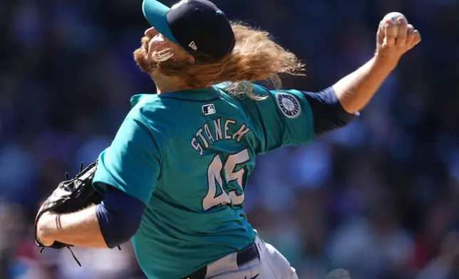 Seattle Mariners relief pitcher Ryne Stanek works against the Colorado Rockies in the eighth inning of the first game of a baseball doubleheader Sunday, April 21, 2024, in Denver. (AP Photo/David Zalubowski)