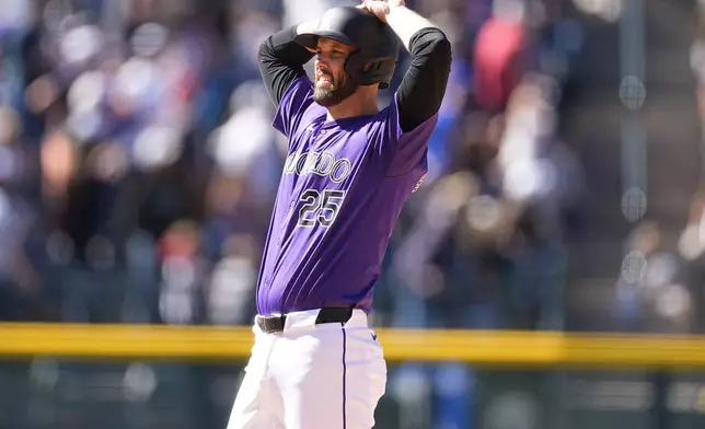 Colorado Rockies' Jacob Stallings reacts after he was called out due to fan interference on a possible winning solo home run in the ninth inning of the first game of a baseball doubleheader against the Seattle Mariners, Sunday, April 21, 2024, in Denver. (AP Photo/David Zalubowski)