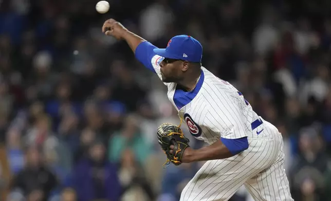 Chicago Cubs relief pitcher Héctor Neris throws during the ninth inning in the second baseball game of the team's doubleheader against the Miami Marlins, Saturday, April 20, 2024, in Chicago. (AP Photo/Charles Rex Arbogast)
