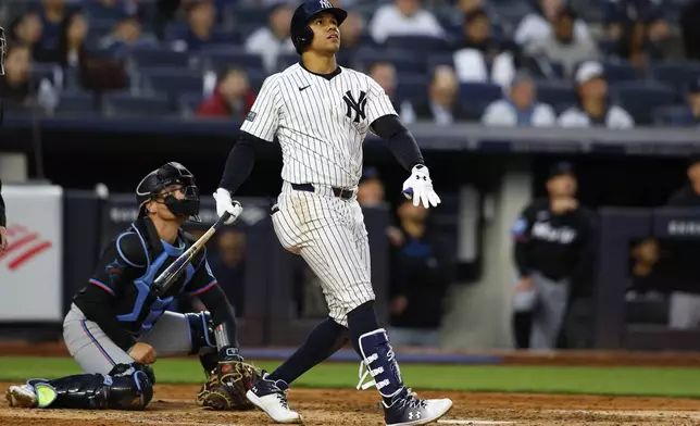 New York Yankees' Juan Soto follows through on a home run against the Miami Marlins during the fourth inning of a baseball game, Monday, April 8, 2024 in New York. (AP Photo/Noah K. Murray)