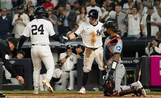 New York Yankees' Alex Verdugo (24) is congratulated by Jon Berti, center right, after hitting a home run in the second inning of a baseball game, Tuesday, April 9, 2024, in New York. (AP Photo/Peter K. Afriyie)