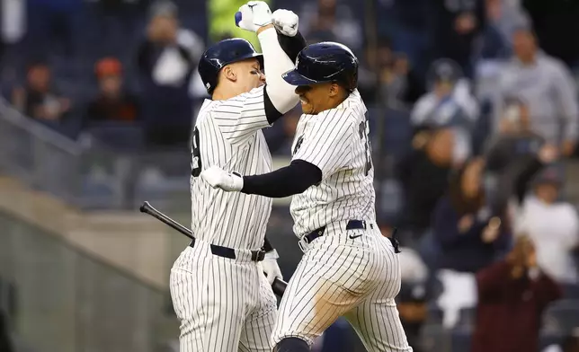 New York Yankees' Juan Soto celebrates with Aaron Judge after hitting a home run against the Miami Marlins during the fourth inning of a baseball game, Monday, April 8, 2024 in New York. (AP Photo/Noah K. Murray)