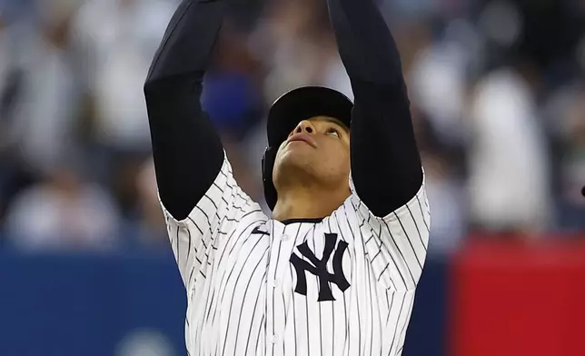 New York Yankees' Juan Soto reacts after hitting a double against the Miami Marlins during the third inning of a baseball game, Monday, April 8, 2024, in New York. (AP Photo/Noah K. Murray)
