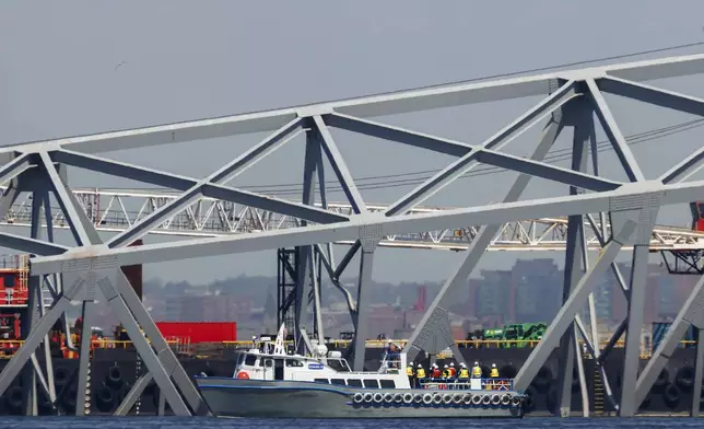 Salvage work continues on the collapsed Francis Scott Key Bridge, Monday, April 15, 2024, in Baltimore. The FBI confirmed that agents were aboard the Dali conducting court-authorized law enforcement activity. (AP Photo/Julia Nikhinson)