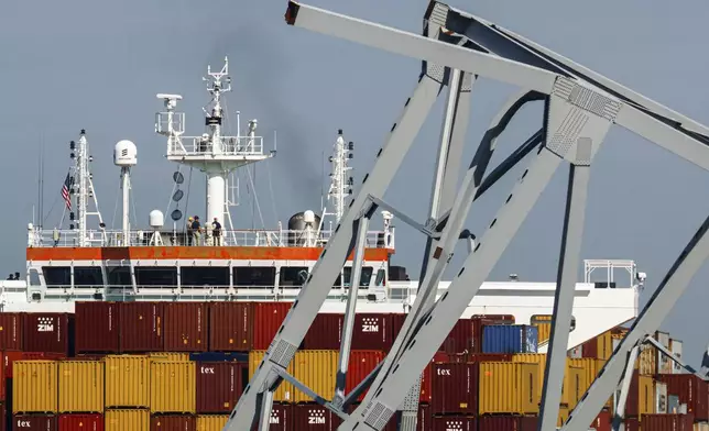 People are seen aboard the container ship Dali, Monday, April 15, 2024, in Baltimore. The FBI confirmed that agents were aboard the Dali conducting court-authorized law enforcement activity. (AP Photo/Julia Nikhinson)