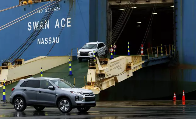Mitsubishi cars are driven off the vehicle carrier Swan Ace at Tradepoint Atlantic, Friday, April 12, 2024, in Sparrows Point, Md. (AP Photo/Julia Nikhinson)