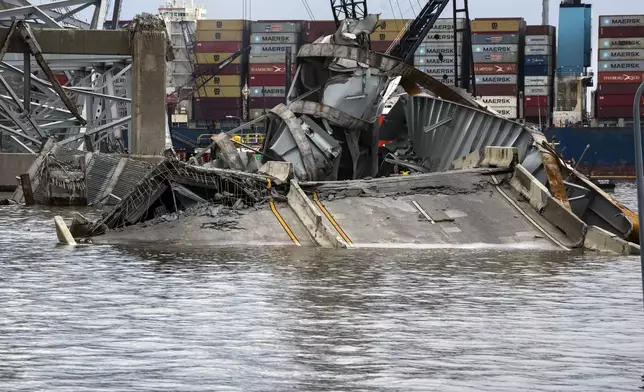 The site of the collapsed Francis Scott Key Bridge and the container ship that toppled it, Dali, are seen from the debris retrieval vessel Reynolds, April 4, 2024, in Baltimore. (Kaitlin Newman/The Baltimore Banner via AP)