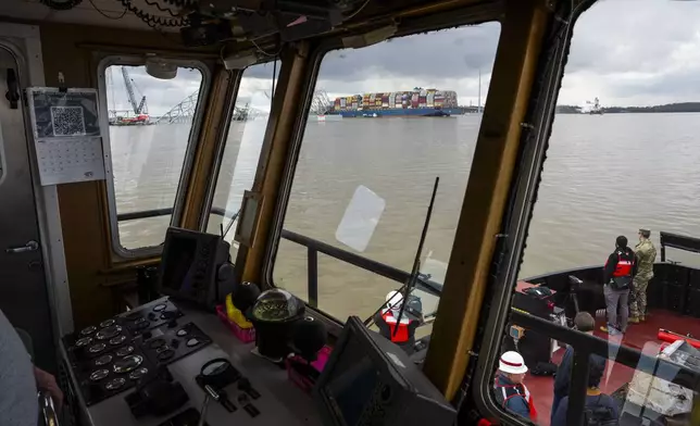 The site of the collapsed Francis Scott Key Bridge and the container ship that toppled it, Dali, are seen from a debris retrieval vessel, the Reynolds, April 4, 2024, in Baltimore. (Kaitlin Newman/The Baltimore Banner via AP)