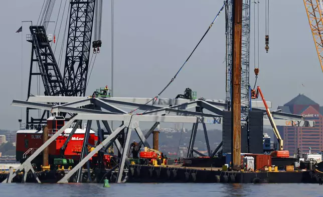 Salvage work continues on the collapsed Francis Scott Key Bridge, Monday, April 15, 2024, in Baltimore. The FBI confirmed that agents were aboard the Dali conducting court-authorized law enforcement activity. (AP Photo/Julia Nikhinson)