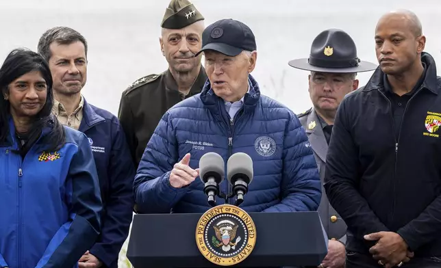 President Joe Biden speaks as Maryland Gov. Wes Moore, right, listens after an operational briefing on the response and recovery efforts of the collapsed Francis Scott Key Bridge, Friday, April 5, 2024, in Dundalk, Md. Looking on at second left is Transportation Secretary Pete Buttigieg. (AP Photo/Julia Nikhinson)