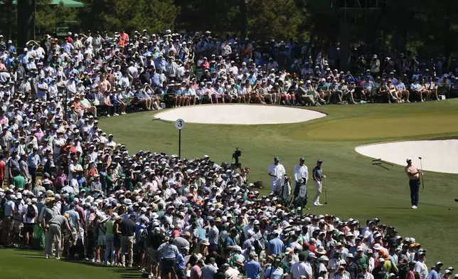 Scottie Scheffler watches his tee shot on the third hole during final round at the Masters golf tournament at Augusta National Golf Club Sunday, April 14, 2024, in Augusta, Ga. (AP Photo/Charlie Riedel)