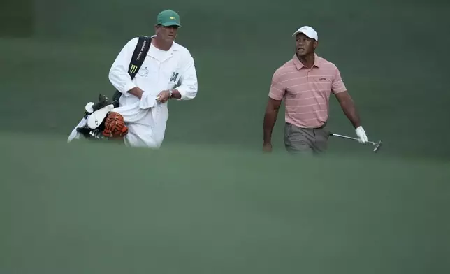 Tiger Woods walks with his caddie on the 13th hole during the first round at the Masters golf tournament at Augusta National Golf Club Thursday, April 11, 2024, in Augusta, Ga. (AP Photo/Ashley Landis)