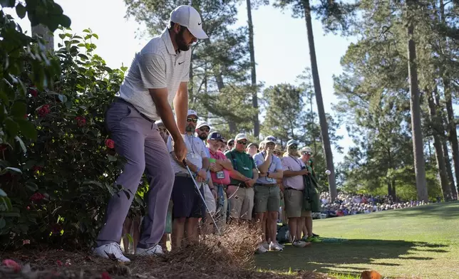 Scottie Scheffler hits from the pine straw on the 10th hole during third round at the Masters golf tournament at Augusta National Golf Club Saturday, April 13, 2024, in Augusta, Ga. (AP Photo/George Walker IV)
