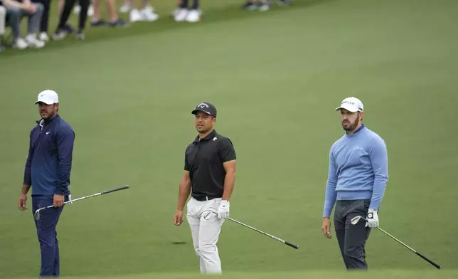 Brooks Koepka, from left, Xander Schauffele and Patrick Cantlay hits on the second hole during a practice round in preparation for the Masters golf tournament at Augusta National Golf Club Tuesday, April 9, 2024, in Augusta, Ga. (AP Photo/Ashley Landis)