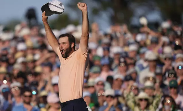Scottie Scheffler celebrates his win at the Masters golf tournament at Augusta National Golf Club Sunday, April 14, 2024, in Augusta, Ga. (AP Photo/Charlie Riedel)