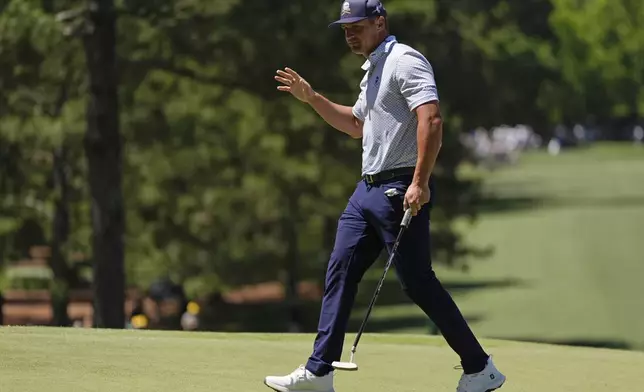 Bryson DeChambeau waves after making a putt on the seventh hole during second round at the Masters golf tournament at Augusta National Golf Club Friday, April 12, 2024, in Augusta, Ga. (AP Photo/Ashley Landis)