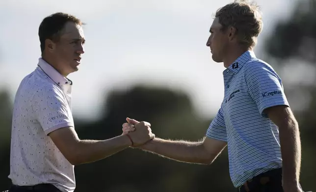 Justin Thomas and Will Zalatoris shake hands after the first round at the Masters golf tournament at Augusta National Golf Club Thursday, April 11, 2024, in Augusta, Ga. (AP Photo/Charlie Riedel)