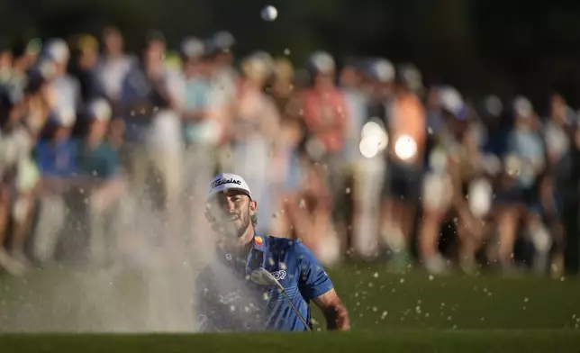 Max Homa hits from the bunker on the 18th hole during third round at the Masters golf tournament at Augusta National Golf Club Saturday, April 13, 2024, in Augusta, Ga. (AP Photo/Charlie Riedel)