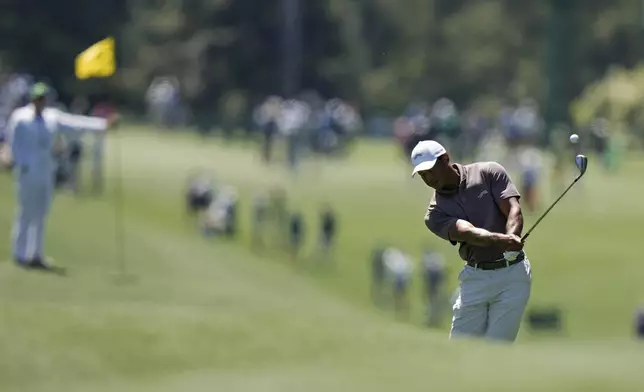 Tiger Woods hits from the fairway on the eighth hole during second round at the Masters golf tournament at Augusta National Golf Club Friday, April 12, 2024, in Augusta, Ga. (AP Photo/Charlie Riedel)