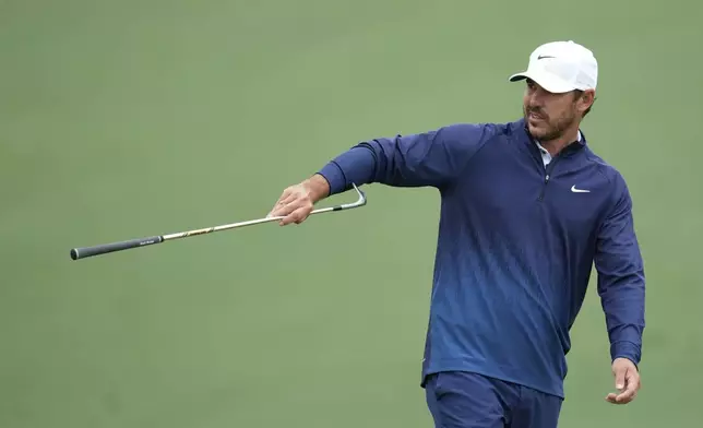 Brooks Koepka hands over his club on the second hole during a practice round in preparation for the Masters golf tournament at Augusta National Golf Club Tuesday, April 9, 2024, in Augusta, Ga. (AP Photo/Ashley Landis)