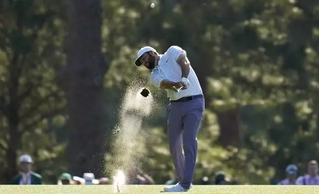 Scottie Scheffler hits from the fairway on the 14th hole during third round at the Masters golf tournament at Augusta National Golf Club Saturday, April 13, 2024, in Augusta, Ga. (AP Photo/Ashley Landis)