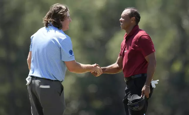 Tiger Woods shakes hand with Neal Shipley after their final round at the Masters golf tournament at Augusta National Golf Club Sunday, April 14, 2024, in Augusta, Ga. (AP Photo/David J. Phillip)