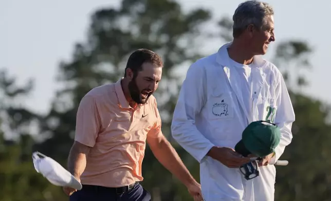 Scottie Scheffler celebrates his win at the Masters golf tournament at Augusta National Golf Club Sunday, April 14, 2024, in Augusta, Ga. (AP Photo/David J. Phillip)