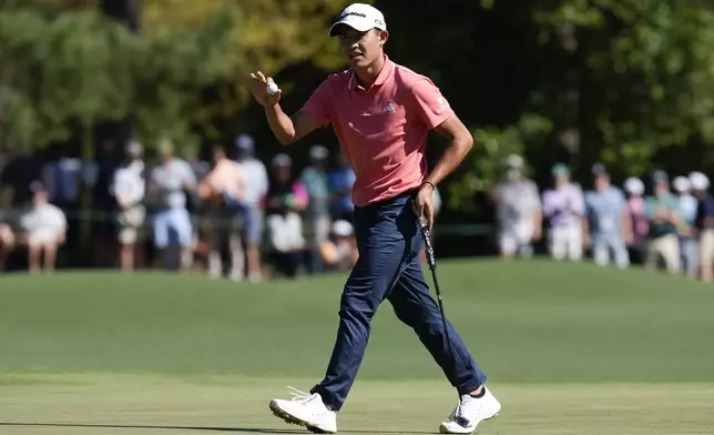 Collin Morikawa waves after making a putt on the eighth hole during third round at the Masters golf tournament at Augusta National Golf Club Saturday, April 13, 2024, in Augusta, Ga. (AP Photo/David J. Phillip)