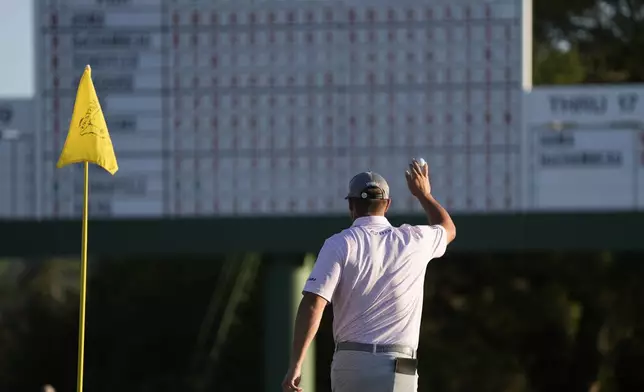 Bryson DeChambeau celebrates after chipping in for a birdie on the 18th hole during third round at the Masters golf tournament at Augusta National Golf Club Saturday, April 13, 2024, in Augusta, Ga. (AP Photo/Charlie Riedel)