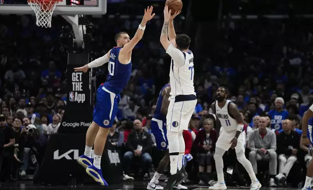 Dallas Mavericks guard Luka Doncic (77) shoots against LA Clippers center Ivica Zubac (40) during the first half of Game 1 of an NBA basketball first-round playoff series in Los Angeles, Sunday, April 21, 2024. (AP Photo/Ashley Landis)